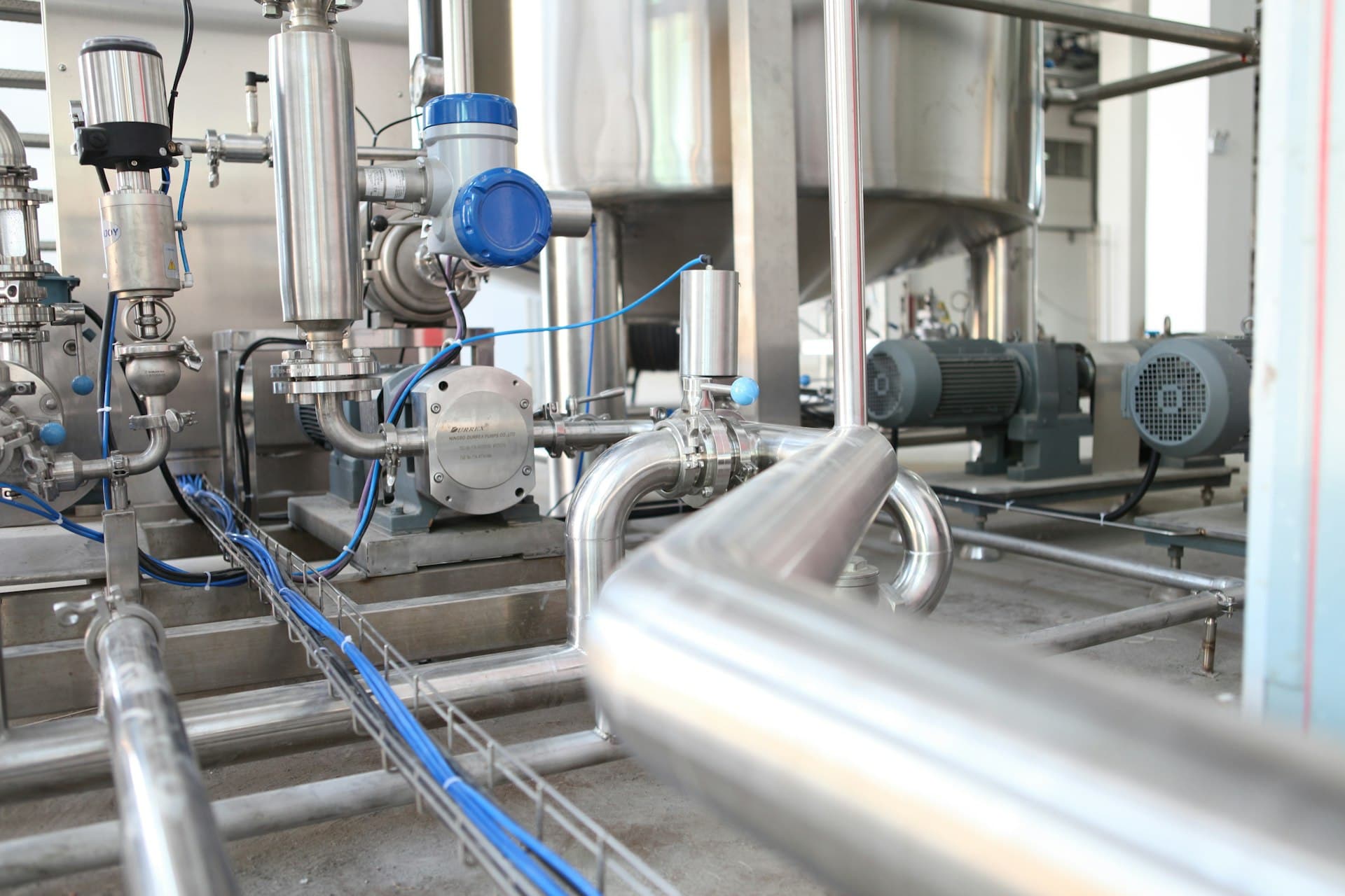 Industrial chemical processing plant with piping and cooling tower