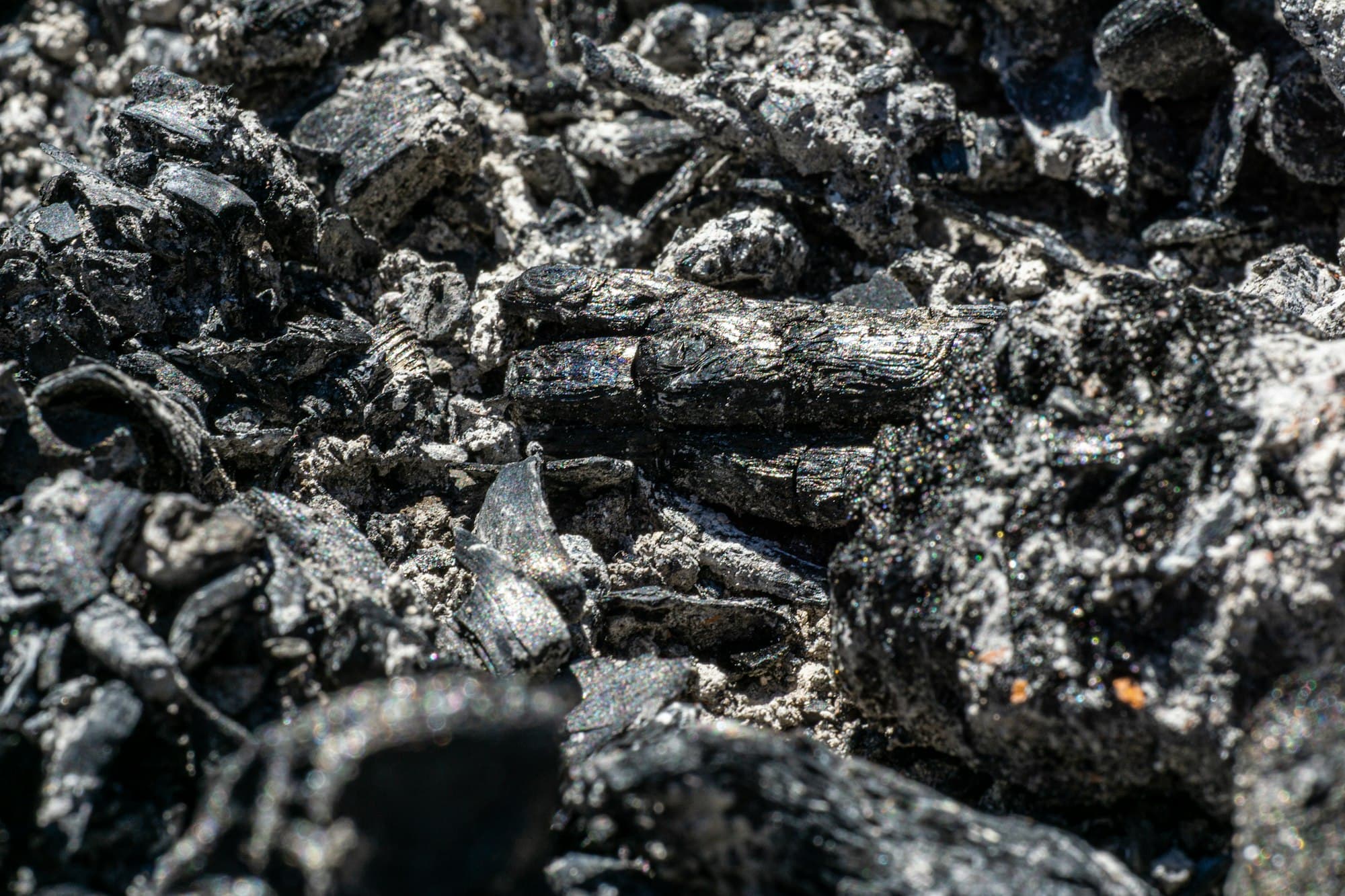 Black petroleum coke lumps in bulk stockpile