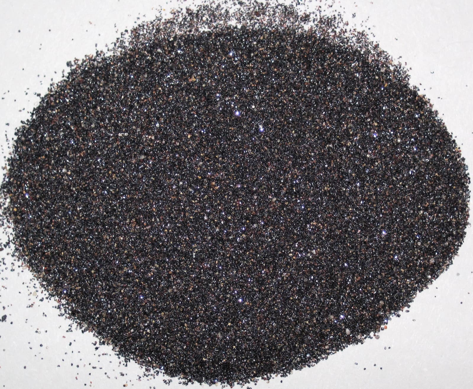 Dark, sparkling rutile-rich heavy mineral sand concentrate